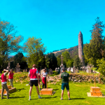 Group taking part in an outdoor Krypton Factor team challenge beside a round tower