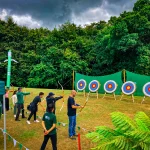Corporate group practising archery during Celtic Games