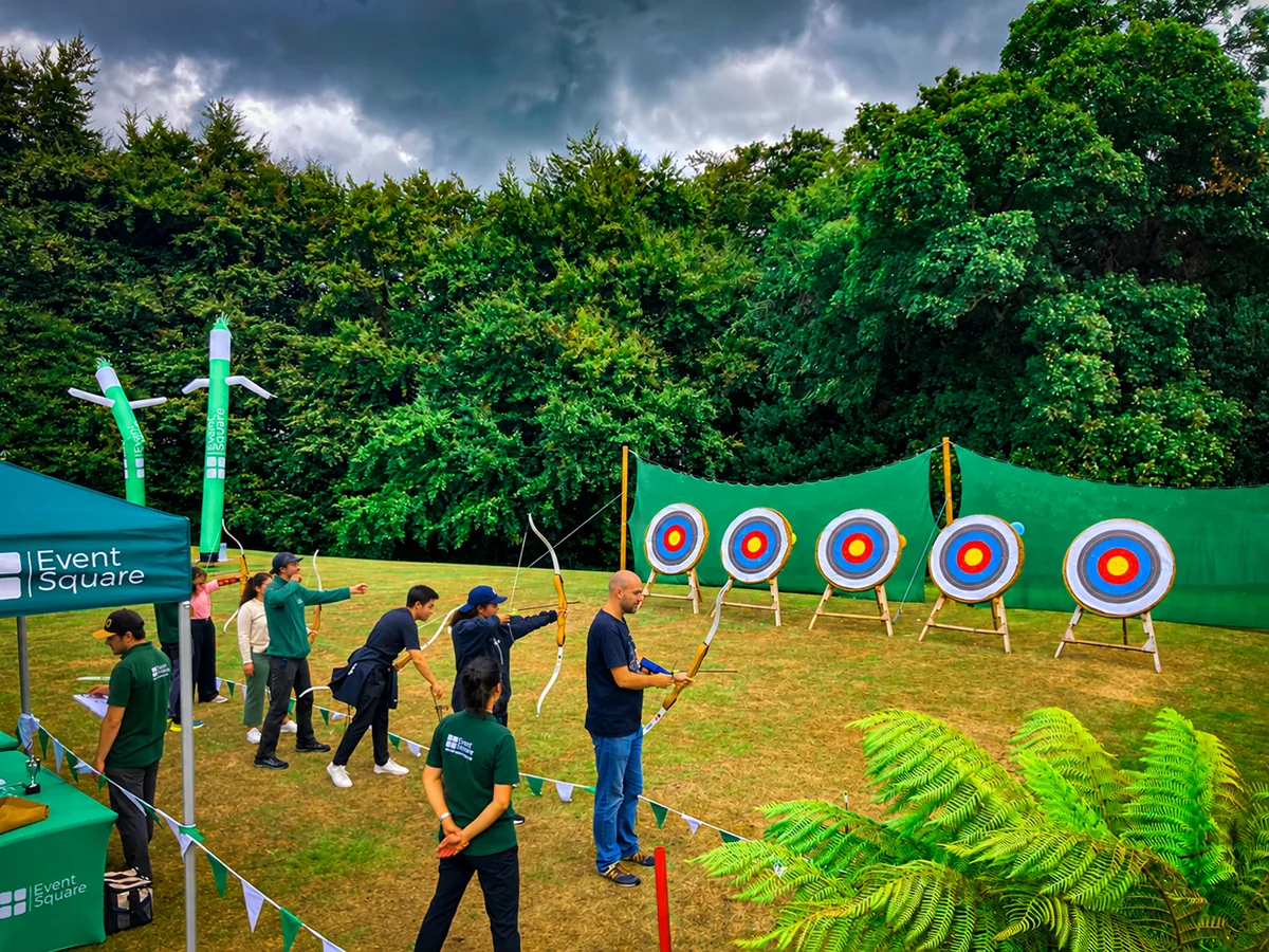 Corporate group practising archery during Celtic Games