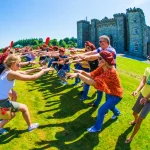 Corporate participants enjoying Celtic Games outside an Irish castle