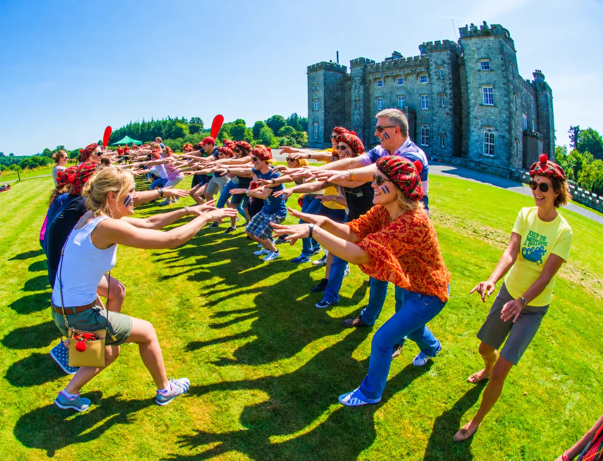 Corporate participants enjoying Celtic Games outside an Irish castle