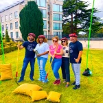 Corporate team beside the Celtic Games sheaf toss station