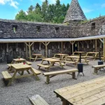 Outdoor courtyard with picnic tables at Glenpark Estate