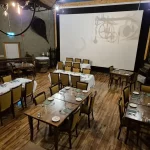 Plough Bar event space with tables and a presentation screen at Glenpark Estate
