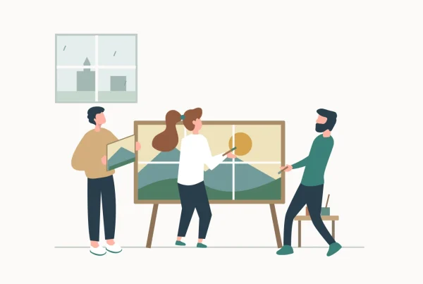 Three colleagues assemble and paint a shared landscape artwork during an indoor team-building activity.