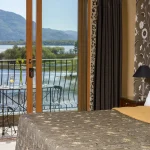 Deluxe bedroom with balcony and lake views at The Lake Hotel in Killarney