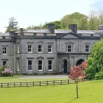 Exterior overview of Temple House with lawns and mature trees
