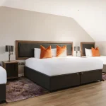 Bedroom with multiple beds at The Malone Hotel in Belfast